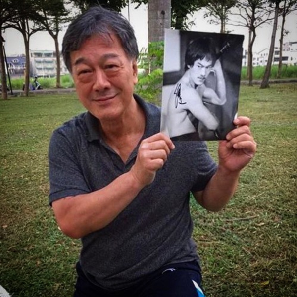 Bruce Li holds a signed photograph of himself during the filming of Michael Worth's 2017 Bruceploitation documentary.
